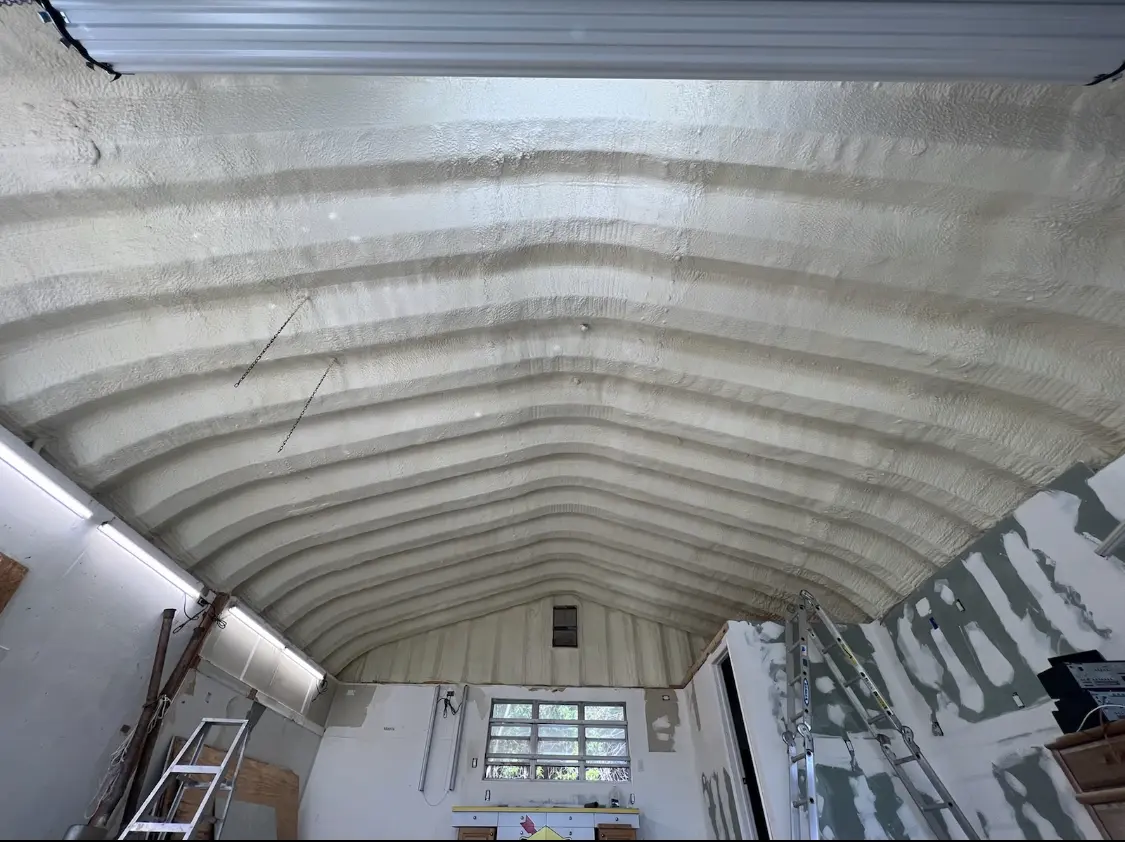 Spray polyurethane foam applied to the underside of a metal roof deck in Lockport